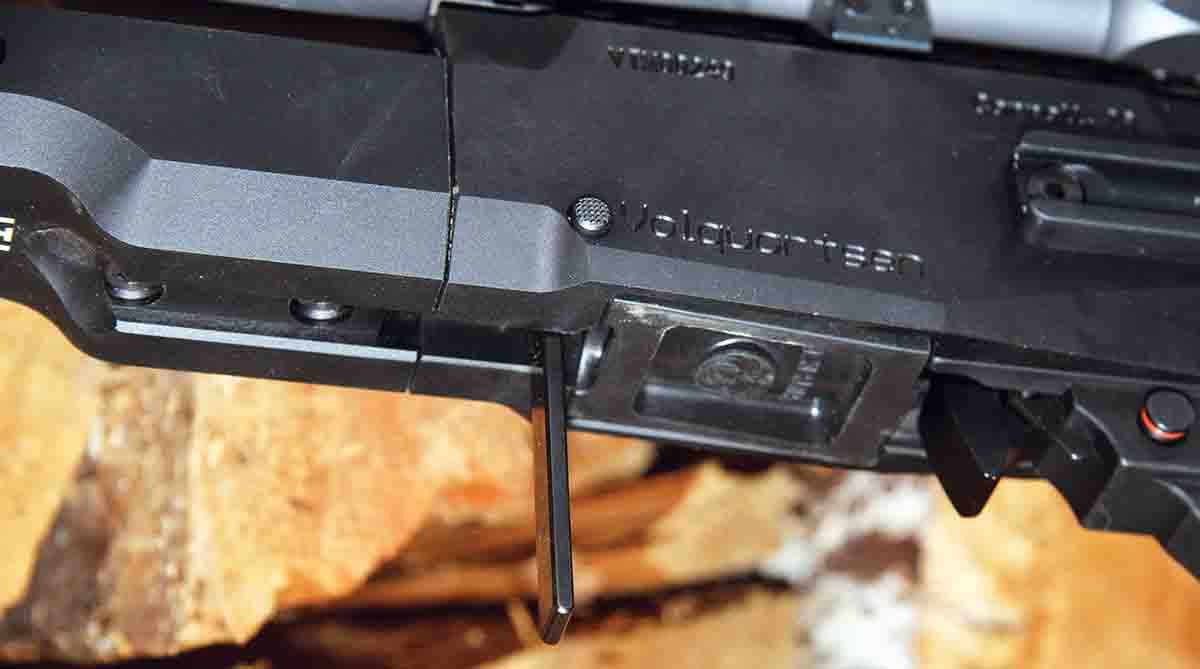 The takedown system on the Volquartsen VT2 requires no tools. A side release button allows a bottom lever to swing downward and unlock the barrel/forearm for disassembly.